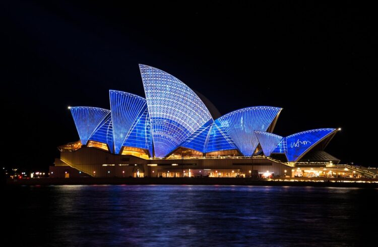 Image of the Sydney Opera House lit up under the black night sky